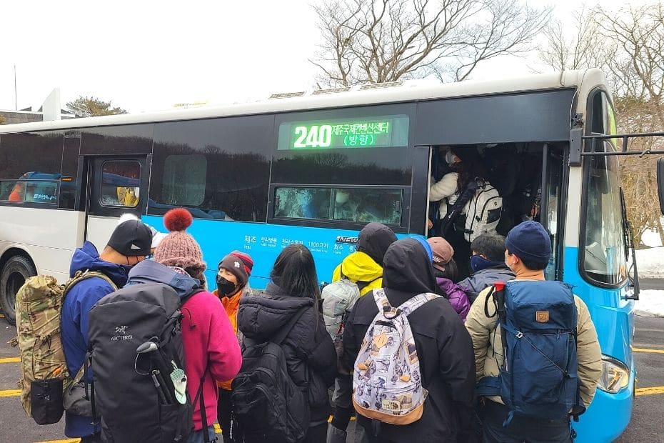 How To Hike Hallasan In Winter: Jeju Island Snow Hiking 2024 15 People crowding onto the 240 bus after hiking Hallasan in winter