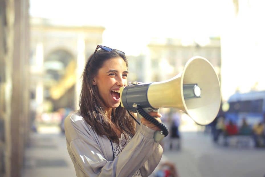 Basic Korean Phrases: 60 Useful Korean Phrases For Travel 2024 6 Woman speaking through a megaphone