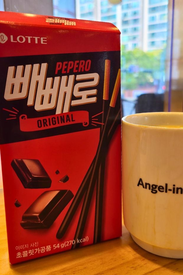 Box of Pepero with a cup of coffee Box of Pepero with a cup of coffee