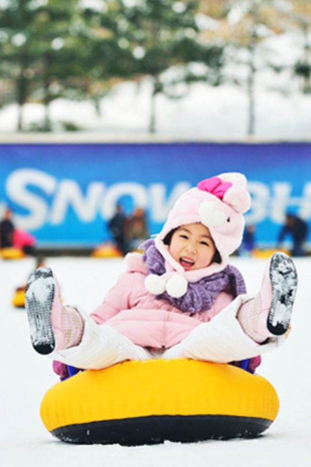 The Best Winter Festivals In Korea You Must Visit In 2024 16 Child on a rubber ring in snow
