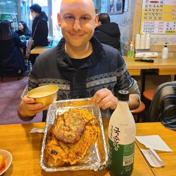 10 Best Traditional Markets In Korea For Food And Shopping 27 Eating bindaetteok in Gwangjang Market
