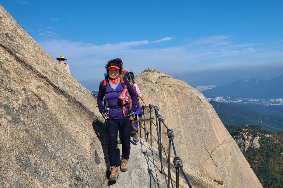 How To Hike Bukhansan Baegundae Peak: Seoul's Best Hike 2024 38 Hiker walking along a rocky path on Baegundae Peak