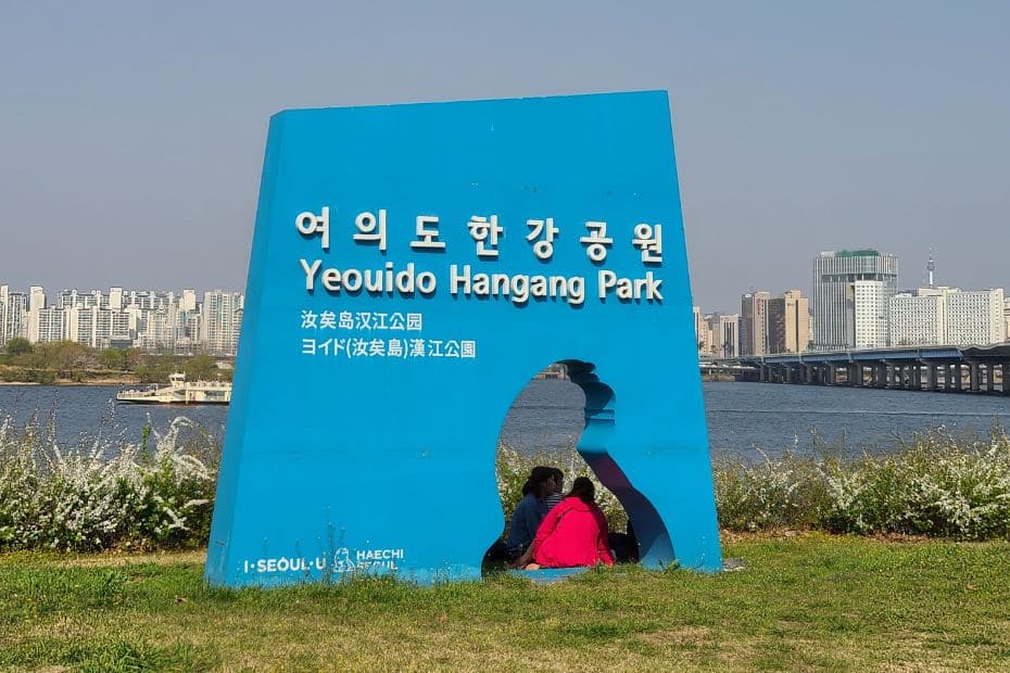 Complete South Korea Travel Guide 2024: Korean Travel Tips 114 Korean and English on a sign in Seoul