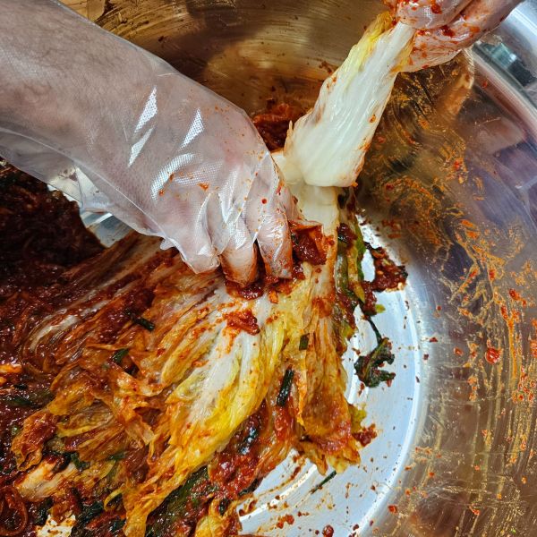 Making kimchi by hand during gimjang Making kimchi by hand during gimjang