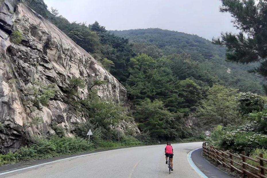 15 Best Places To Go Cycling In Korea: From Coast To Mountains 17 Man cycling along a bike path in Korea