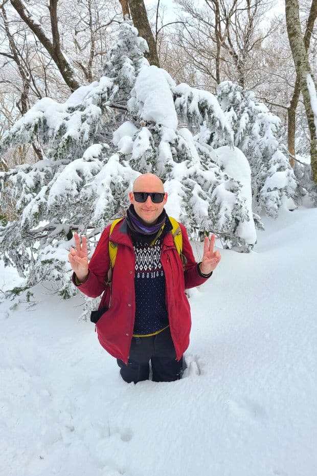What To Do On Jeju Island In Winter: Jeju Winter Itinerary 2024 9 Man in deep snow on Hallasan Mountain