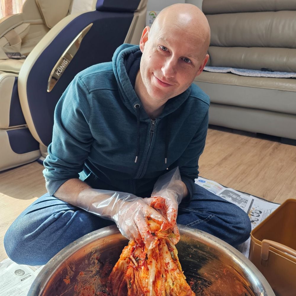 I Tried Kimjang! Korean Kimchi Making Day Is Tough But Fun 5 Man making kimchi on kimchi making day