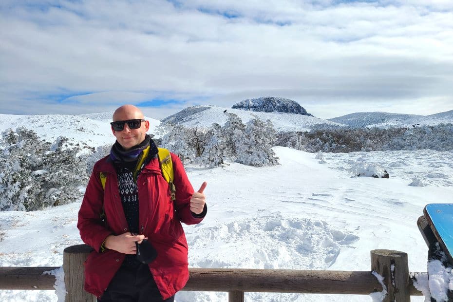 What To Do On Jeju Island In Winter: Jeju Winter Itinerary 2024 26 Man overlooking the peak of Hallasan Mountain in snow