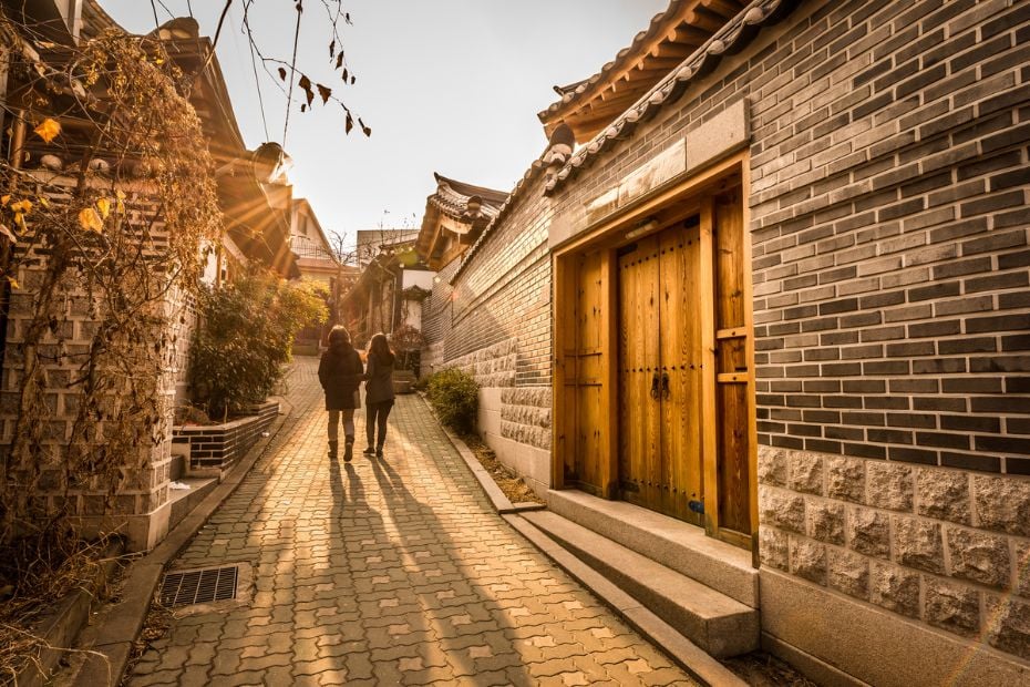 What To See And Do in Bukchon Hanok Village Seoul In 2024 7 People exploring Bukchon Hanok Village at dusk