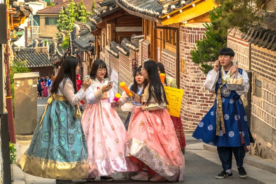 What To See And Do in Bukchon Hanok Village Seoul In 2024 4 People in hanbok in Buckhon Hanok Village Seoul