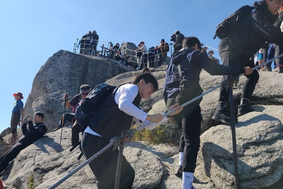 How To Hike Bukhansan Baegundae Peak: Seoul's Best Hike 2024 41 People queueing to take a photo at Baegundae Peak