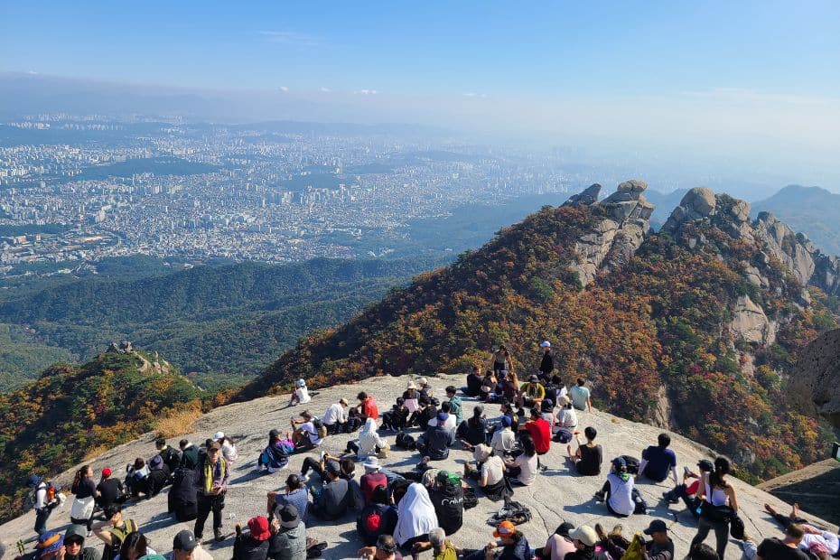 How To Hike Bukhansan Baegundae Peak: Seoul's Best Hike 2024 39 People resting and views of Seoul from Baegundae Peak