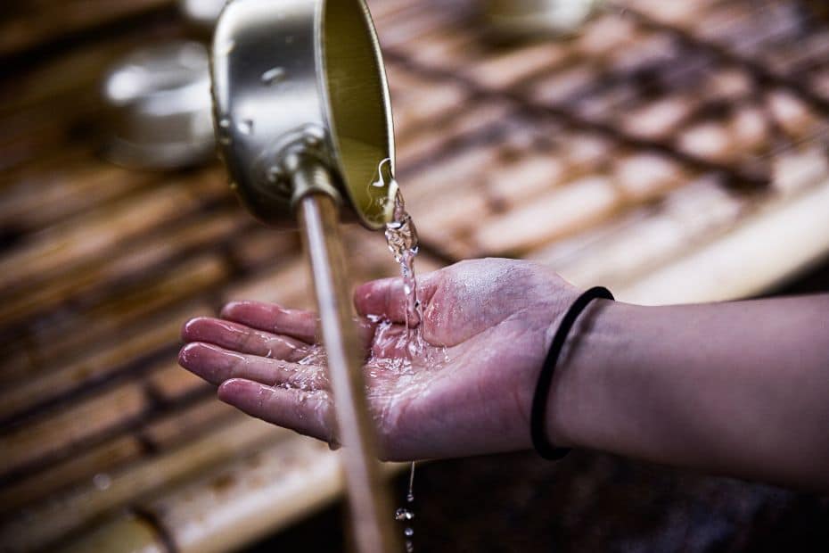 Complete South Korea Travel Guide 2024: Korean Travel Tips 117 Person washing their hands at a temple in Korea