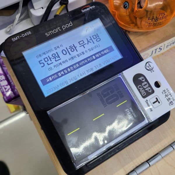Korea's T-Money Card: The Ultimate Guide 2024 37 T-Money card being recharged at a convenience store