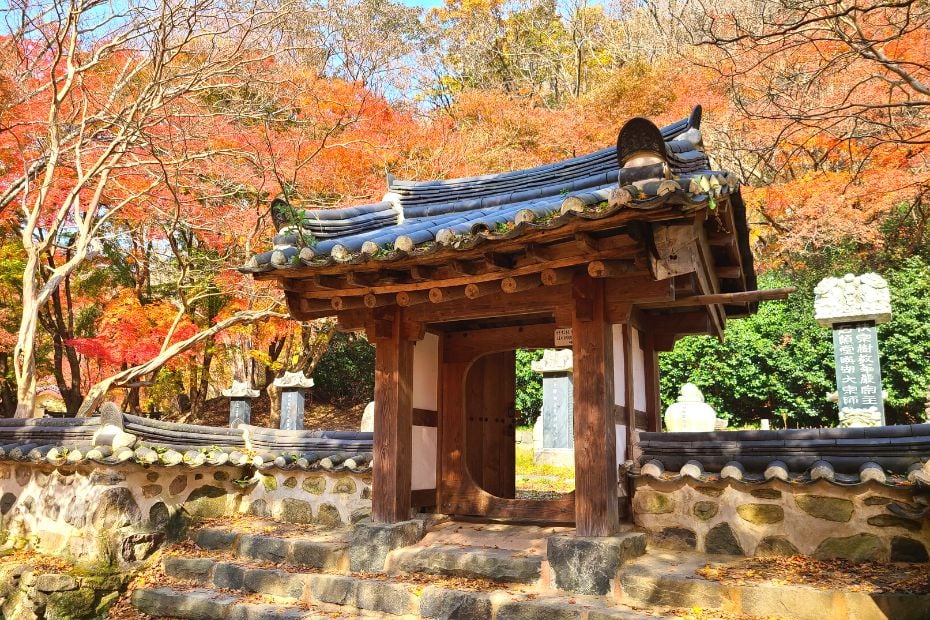 Korea In October 2024: Best Festivals, Events, And Sights 9 Traditional Korean gate with autumn foliage