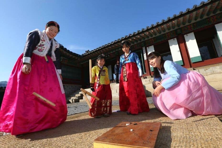 50 Amazing South Korean Culture Facts You'll Love 2024 10 Korean family playing yut nori during a Korean holiday
