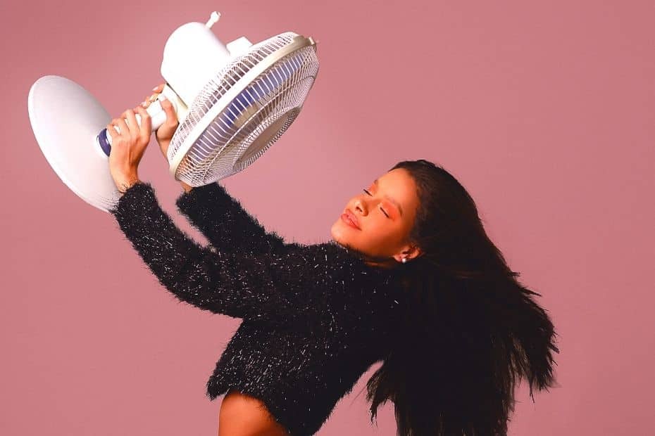 How To Survive Summer In Seoul 2024: 10 Tips To Stay Cool 13 Woman keeping cool with a fan