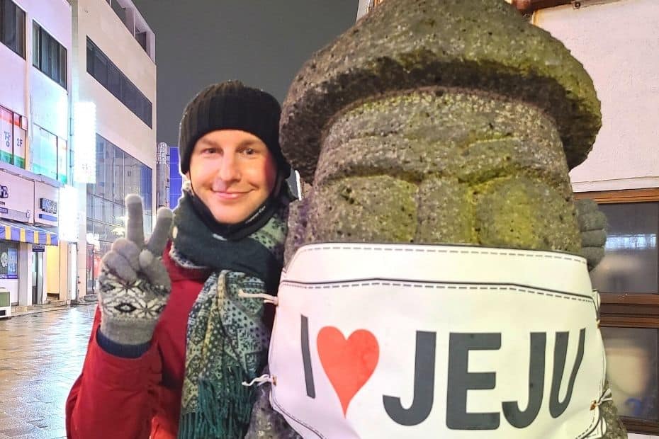 Expat Life In Korea: A Guide To Living In Korea As An Expat 13 Standing next to a dol-hareubang with face mask in Jeju City