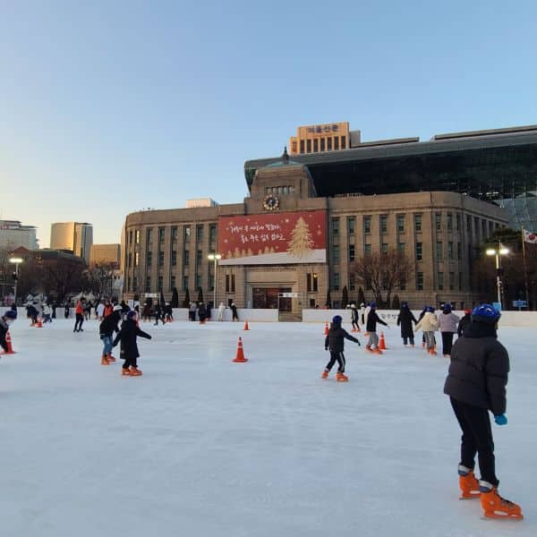 People ice skating outside City Hall in Seoul People ice skating outside City Hall in Seoul