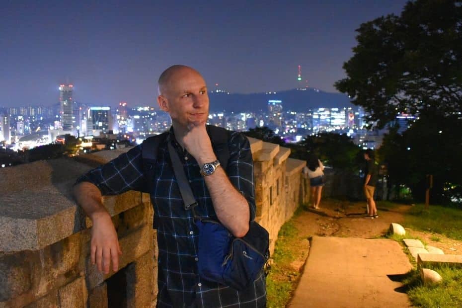 How To Survive Summer In Seoul 2024: 10 Tips To Stay Cool 9 Joel standing by the Seoul Fortress Wall at night in summer in Seoul