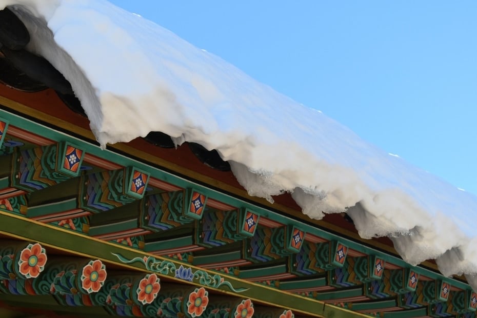 A Guide To Winter In Korea 2024: 20+ Best Winter Activities 14 Snow on a Korean palace roof in winter
